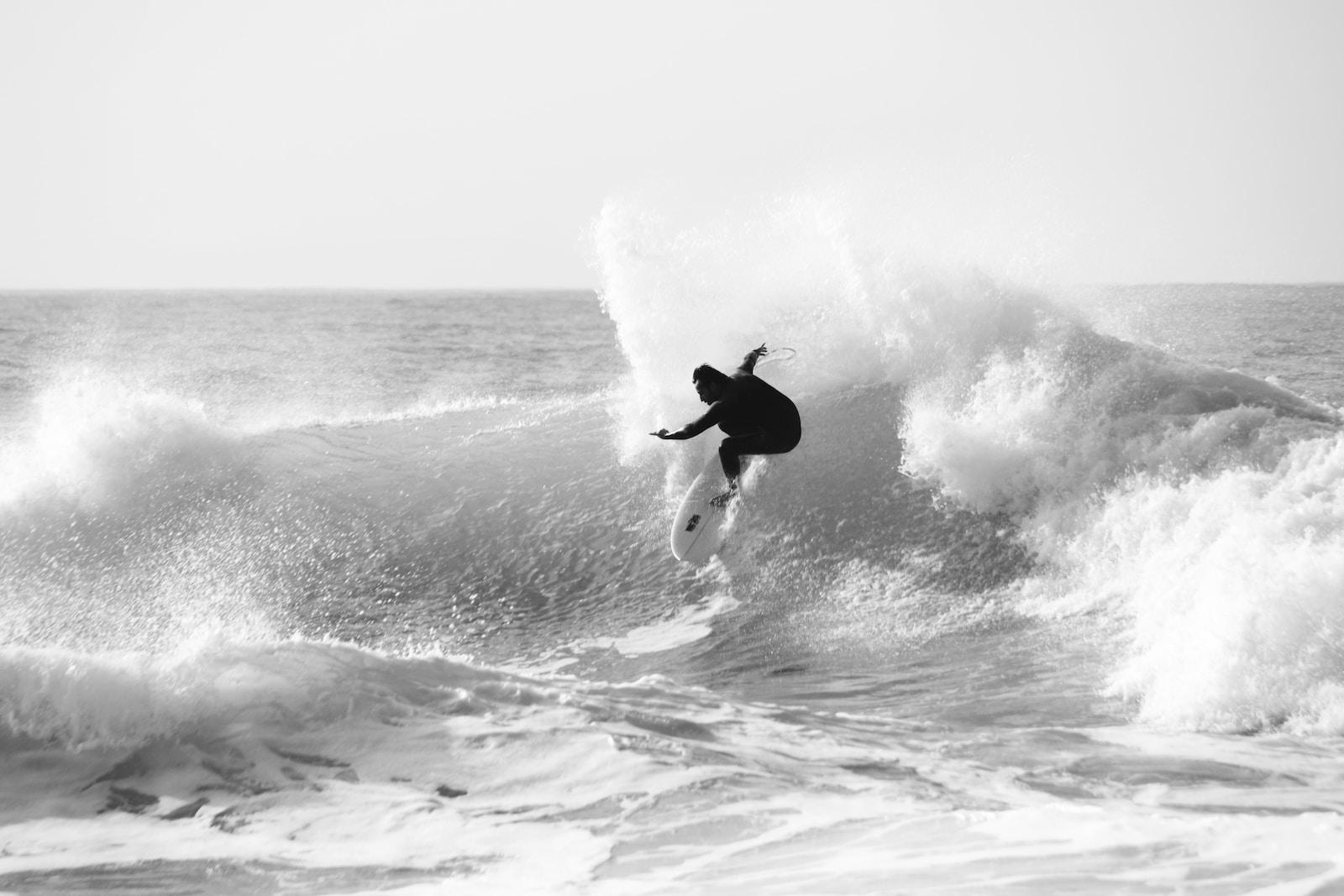 a man riding a wave on top of a surfboard