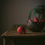 red strawberries on brown wooden table